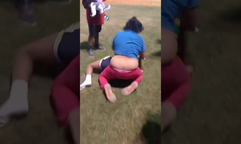 Two girls fighting at the fair
