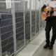 Animal service officer sings and plays guitar for shelter dogs