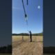 Archer Shoots Arrow Into Horizontally Hanging Pole Through Swinging Ring