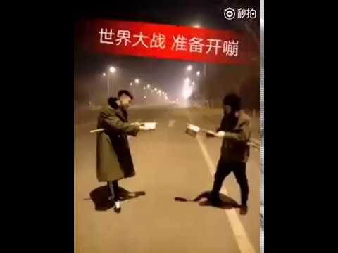 Extremely dangerous street fight: Two guys launch firework fight during Spring Festival