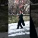 Guy Slides Down Icy Road While Wearing Suit and Holding Wine Glass in his Hand