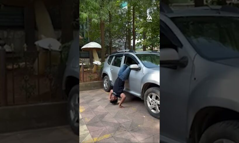 Man Enters Car While Doing Handstand