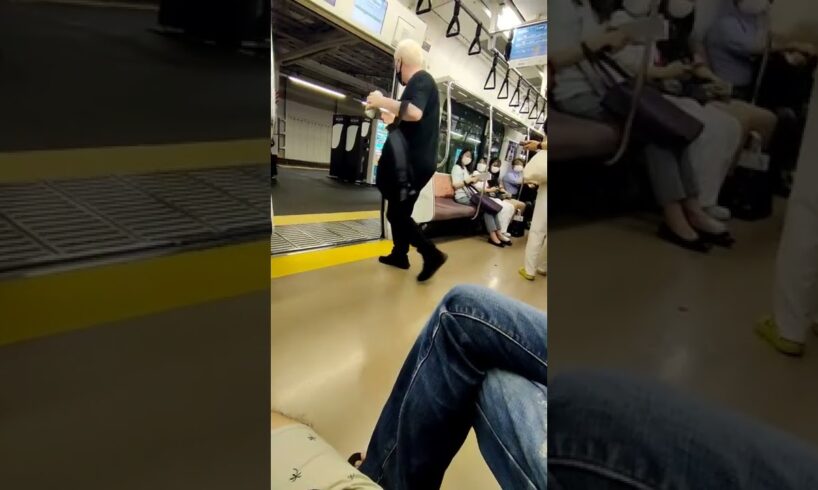 Japanese man tries to drag foreigner off the train for being loud and drinking.