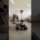 Boy Chilling Indoors Casually Flicks Ball into Basket Without Looking