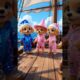 Three cute golden retriever puppies are out sailing and dancing.